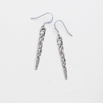 pewter icicle earrings laying flat on a white background