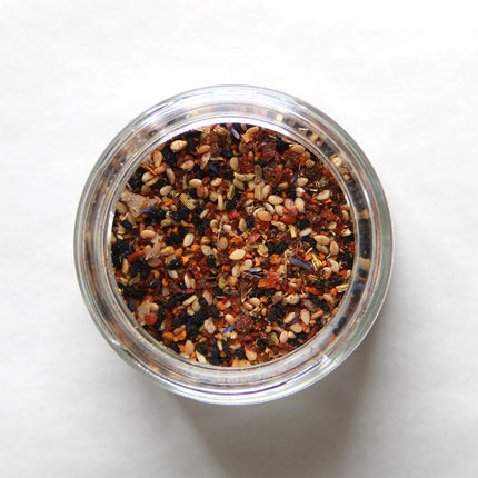 an above view of an open jar of Everything Rainbow showing the vibrant spectrum of color in this versatile spice blend