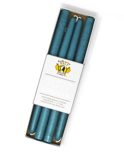 four colonial blue taper candles in a rectangular box with a white label