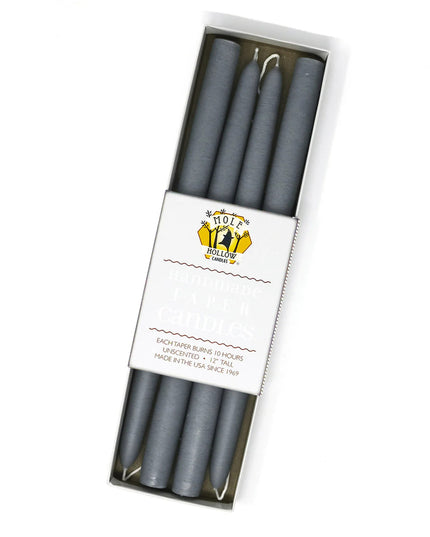 four slate grey taper candles in a rectangular box with a white label