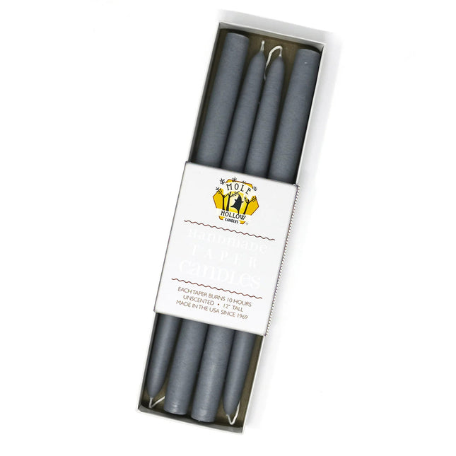 four slate grey taper candles in a rectangular box with a white label