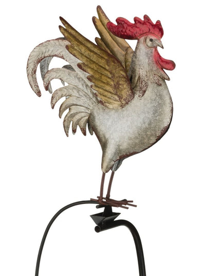 A metal garden stake featuring a colorful rooster with detailed feathers, perched on a rocker that moves in the wind.