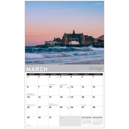 Calendar with March 2023 dates and a scenic image of a building by the sea.