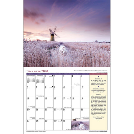interior page of the Weather 2026 calendar showing the December page featuring an icy wheat field with a charming windmill in the background
