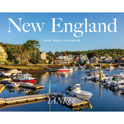 New England 2027 wall calendar cover featuring a scenic harbor with boats, docks, and coastal houses under a blue sky, with large white 'New England' text at the top and 'YANKEE' near the bottom.