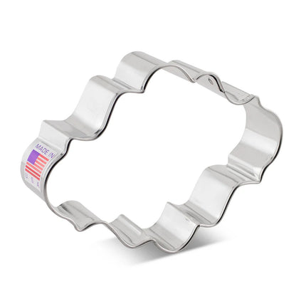an oval cookie cutter with ornate edging