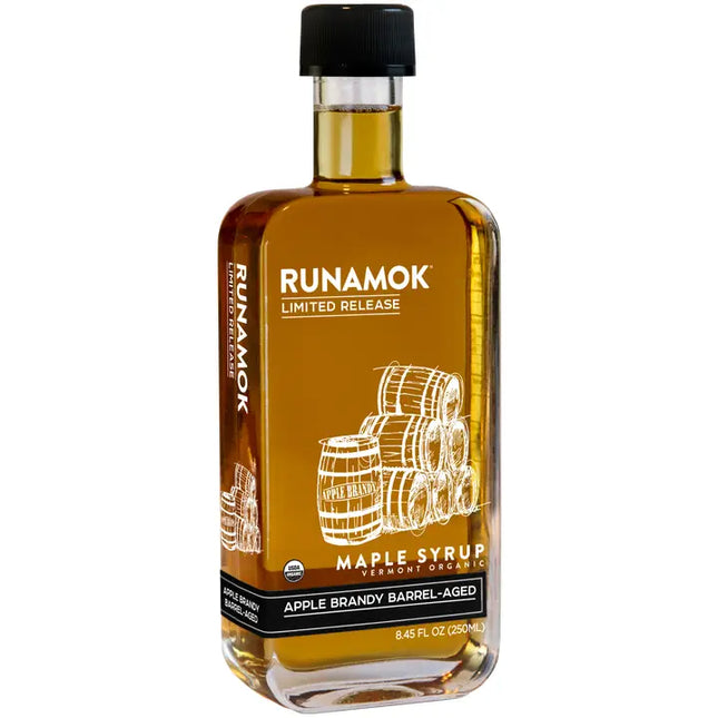 Bottle of Runamok maple syrup with barrels on a white background