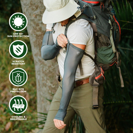 a model in the woods with a sun hat, backpack, and wearing the gray protection sleeves. text around the image reads "UPF 50+ Protection, Scratch Resistant, Bug Bite Protection, and Cooling & Breathable"