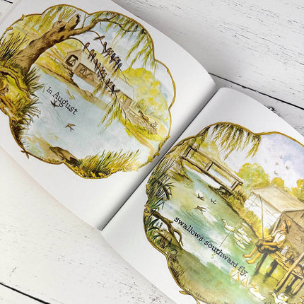Open book with illustrated pages featuring nature scenes and text.
