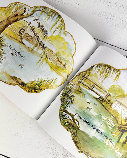 Open book with illustrated pages featuring nature scenes and text.