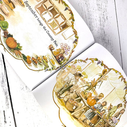 Illustrated pages from a book about September and the Country Fair, featuring pumpkins and people.