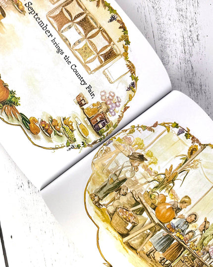 Illustrated pages from a book about September and the Country Fair, featuring pumpkins and people.