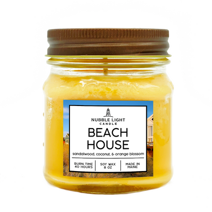 Jar candle labeled 'Beach House' by Nubble Light Candle on a white background