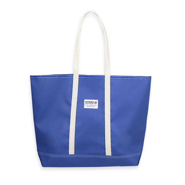 Blue tote bag with white handles on a white background