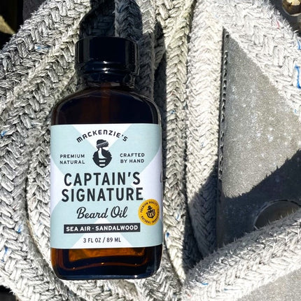 a bottle of Captain's Signature Beard Oil on a boat