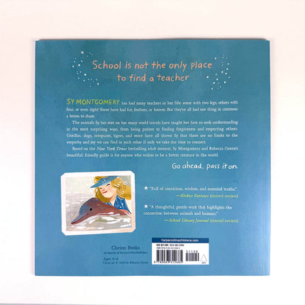Book back cover with text and illustration of a girl with a dolphin on a blue background