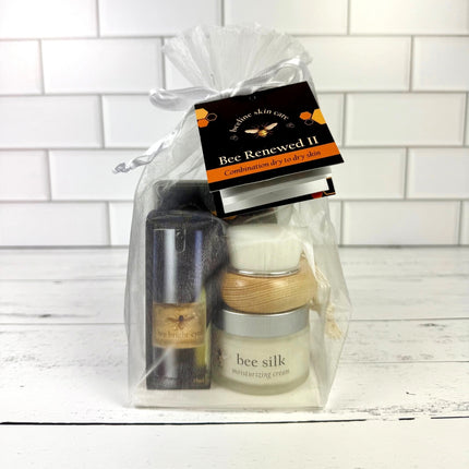 Skincare product set in a clear gift bag with a white tiled background
