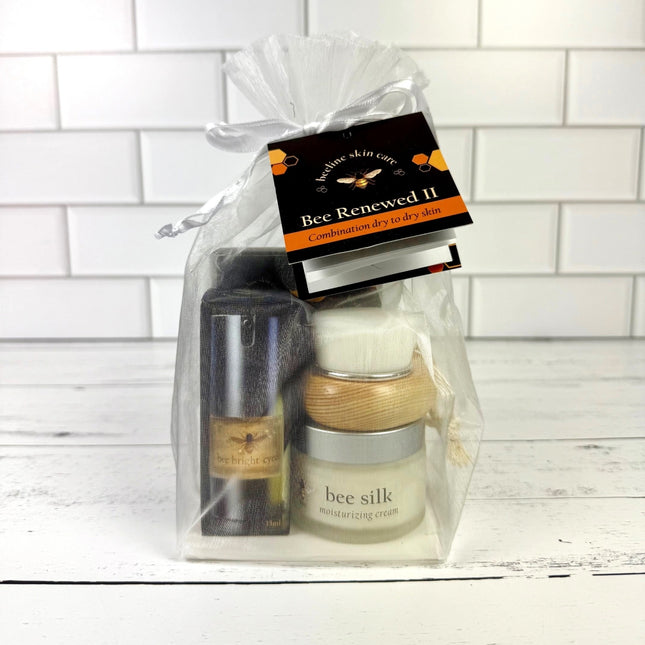 Skincare product set in a clear gift bag with a white tiled background