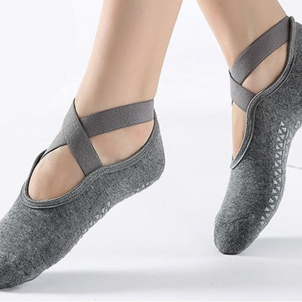a pair of feet mid-step wearing the gray, 100% cotton socks