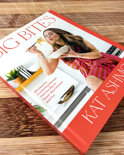 Book titled 'Big Bites' by Kat Ashmore on a wooden surface