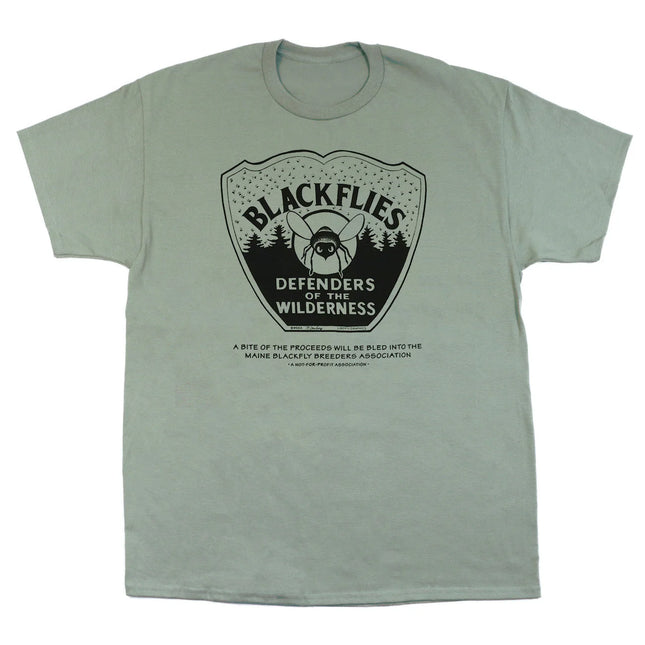 Light green t-shirt with black graphic of a blackfly on an emblem with the text "Blackflies Defenders of the Wilderness"