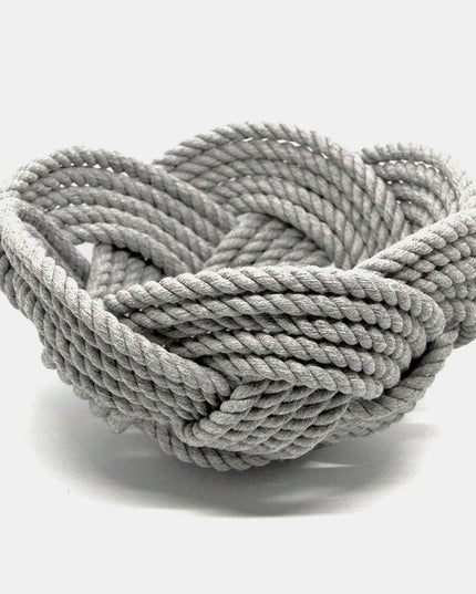 a hand woven cotton rope bowl in gray against a white background