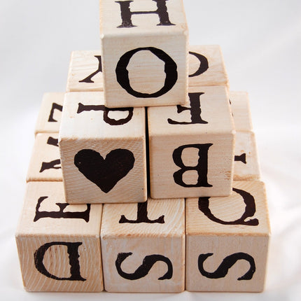 a pyramid of lettered blocks