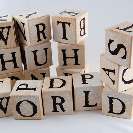 a random assortment of lettered blocks stacked and piled together