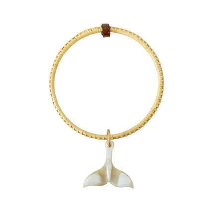 woven, wooden bangle bracelet with a whale tail charm on a white background