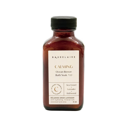 an amber colored apothecary style bottle with a black cap and off white label that reads "Baudelaire - Calming - Ocean Breeze Soak no. 13 - Sea Fennel - Lavender - Driftwood"