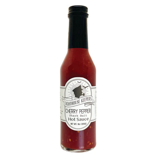 a tall slender bottle of cherry pepper hot sauce