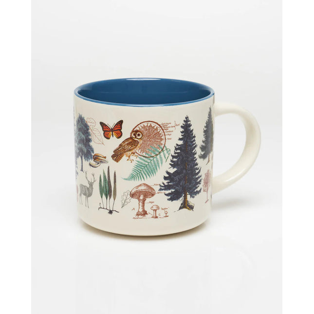 the other side of a white coffee mug with more vintage illustrations of woodland flora and fauna wrapping around it, and a solid deep blue print on the inside of the mug