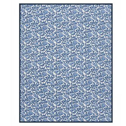 Blue and White shells and coral themed blanket laid flat against a white background