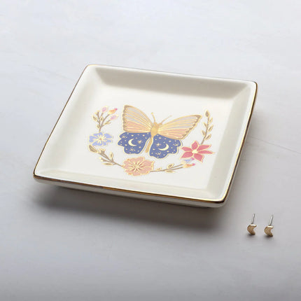Decorative trinket dish with butterfly design on a light gray background