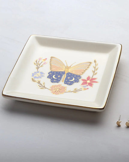 Decorative trinket dish with butterfly design on a light gray background
