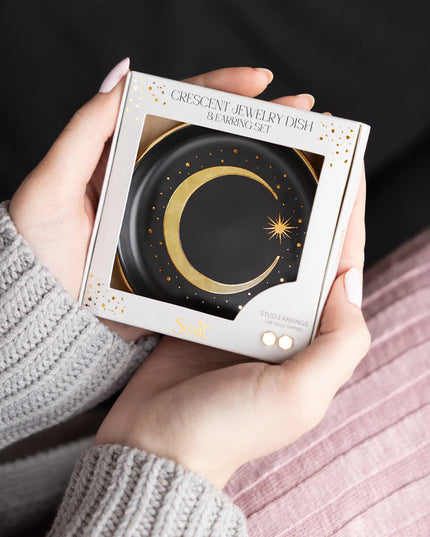 Person holding a box of a crescent jewelry dish packaging set.