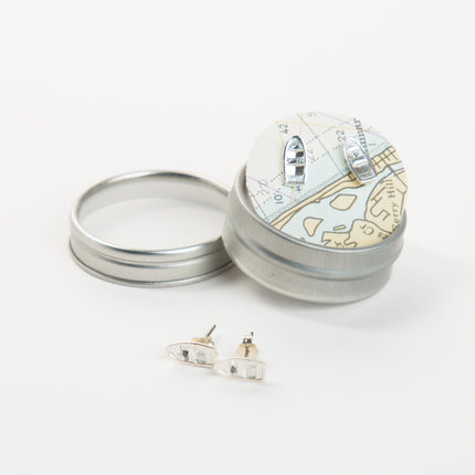 Silver jewelry box with earrings on a white background
