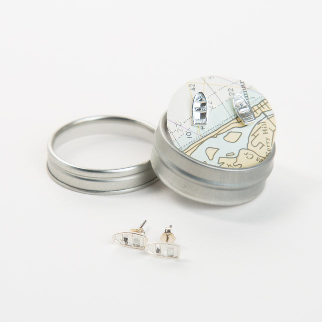 Silver jewelry box with earrings on a white background