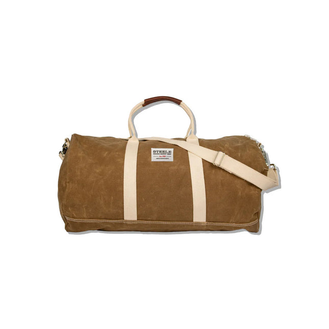 a brown waxed canvas duffle bag with white straps and leather handles against a white background