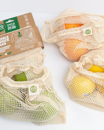 Reusable produce bags with fruits and packaging on a white background