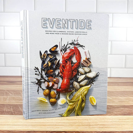 Cookbook titled 'Eventide' with a cover featuring seafood on a wooden surface.