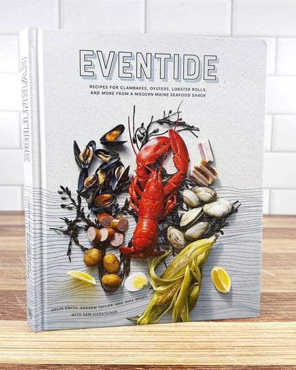 Cookbook titled 'Eventide' with a cover featuring seafood on a wooden surface.