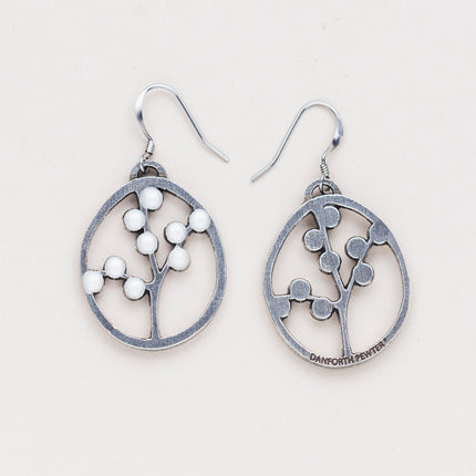 a pair of oval pewter earrings with branches inside adorned with white beads to represent blossoms with one turned over to show the all silver backside with the Danforth Pewter makers mark