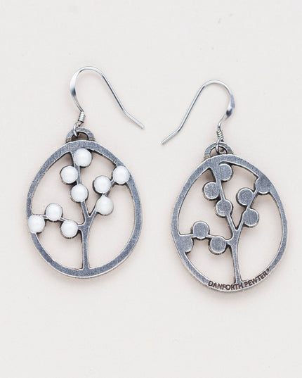 a pair of oval pewter earrings with branches inside adorned with white beads to represent blossoms with one turned over to show the all silver backside with the Danforth Pewter makers mark