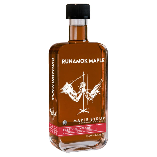 A bottle of festivus infused maple syrup against a white background