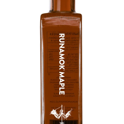 A side view of a bottle of festivus infused maple syrup against a white background
