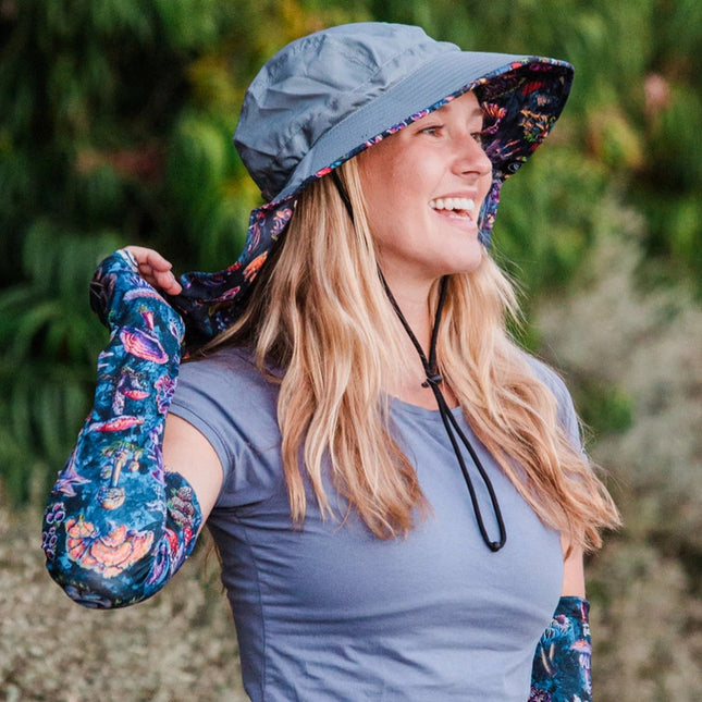 a model wearing the Sun Hat and matching protection sleeves outdoors