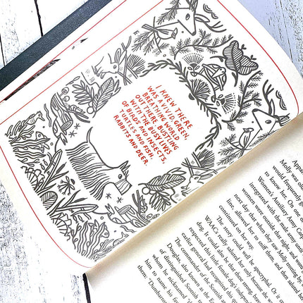 Book with decorative illustrations of animals and text on a textured surface