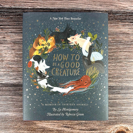 Book cover of 'How to Be a Good Creature' on a wooden surface