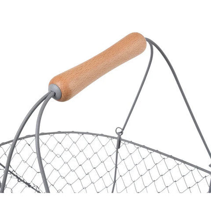 a close up of the smooth wooden handle on the large harvest basket